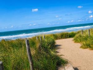 a path to the beach with the ocean in the background at Modern Studio with Sea View and Balcony in Middelkerke +5 photos