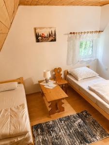 a small room with a bed and a table at Pogórzański Domek in Ciężkowice