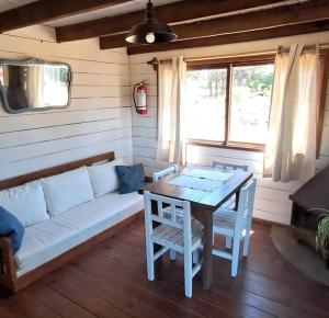 a living room with a couch and a table at Villa Gutierrez4 in Punta Del Diablo