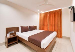 a bedroom with a large bed and a window at SEA BEACH HOTEL Near Swargadwar-Golden Beach- Jagannath Temple - PARK , Fully Air Conditioned Rooms ,Wifi , Lift , And Free Parking , BEST HOTEL IN PURI in Puri