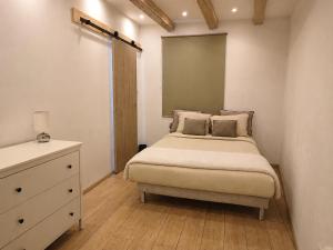 a small bedroom with a bed and a dresser at Home Dream/Erstein/3P/60m2 in Erstein