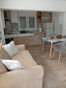 a living room with a couch and a table at LOUKIA'S HOUSE in Skala Kallirachis