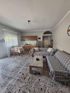 a living room with a couch and a table at Eva's house in Xanthi