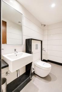 a bathroom with a sink and a toilet at SEA BEACH HOTEL Near Swargadwar-Golden Beach- Jagannath Temple - PARK , Fully Air Conditioned Rooms ,Wifi , Lift , And Free Parking , BEST HOTEL IN PURI in Puri