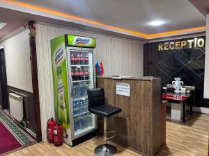 a soda machine in a room with a bar at Elit Hotel in Mingachevir +9 photos