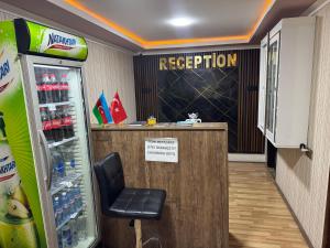 a waiting room with a refrigerator and a chair at Elit Hotel in Mingachevir