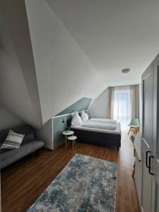a bedroom with a bed and a couch and a rug at Hotel Am Wintergarten in Bocholt +54 photos