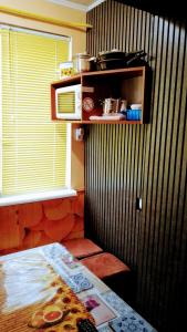 a room with a bed and a microwave on a wall at Небольшая СТУДИЯ, проспект ЦЕНТРАЛЬНЫЙ 124А, 2 дивана, 2 кресла 3 этаж 9 этажного дома Wi-Fi in Mykolaiv