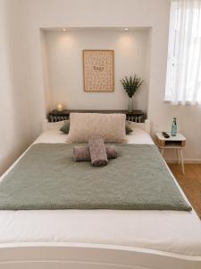 a large white bed with two pillows on it at Guesthouse - Weeze Rooms in Weeze +24 photos