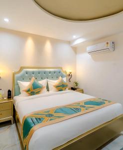 a bedroom with a large bed in a room at Studio by Jardin in Indore