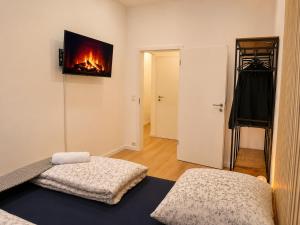 a living room with a fireplace on the wall at City Line Koblenz in Koblenz +3 photos