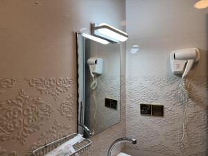 a bathroom with a shower and a sink with a mirror at Modern Palace Hotel in Al Fayşalīyah +34 photos