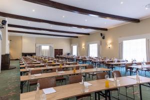 a large room filled with tables and chairs at Troutbeck Resort in Nyanga
