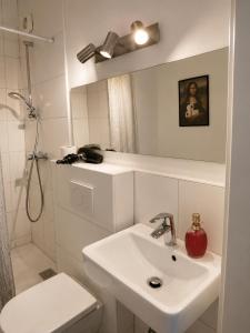 a white bathroom with a sink and a toilet at Guesthouse - Weeze Rooms in Weeze