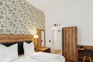 a hotel room with a bed and a chair at Hopfenquartier Altstadt in Bamberg