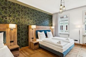 a bedroom with a large bed and a green wall at Hopfenquartier Altstadt in Bamberg