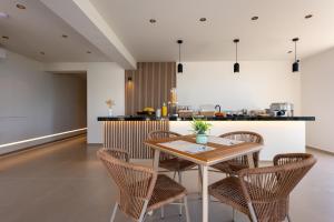 a kitchen with a wooden table and chairs at Zofeni in Póndi