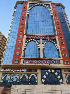a tall building with a lot of windows at فندق نمبر وان 3 in Al Masfalah
