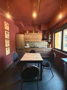 a kitchen with a table and chairs in a room at Chillout Hostel Zagreb in Zagreb