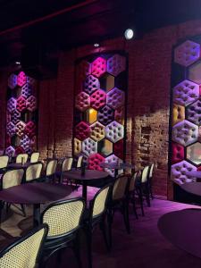 a dining room with tables and chairs and a wall of wine bottles at Timeout Heritage Hotel Zagreb in Zagreb