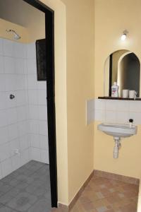a bathroom with a sink and a mirror at Maya Comforts in Ukunda