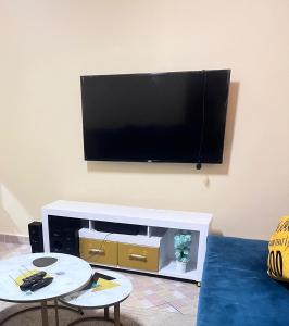 a living room with a flat screen tv on a wall at Maya Comforts in Ukunda