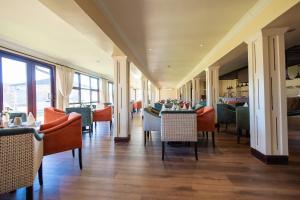 a dining room with chairs and tables in a restaurant at Troutbeck Resort in Nyanga
