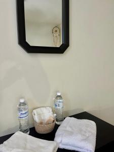 a table with two bottles of water and a mirror at Neska Polita Hostel in Juayúa