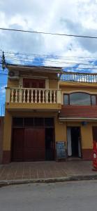 a yellow house with a balcony on top of it at Ciudad de Nieva a pasos de Ciudad Cultural in San Salvador de Jujuy