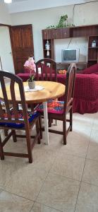 a wooden table and chairs in a room at Ciudad de Nieva a pasos de Ciudad Cultural in San Salvador de Jujuy