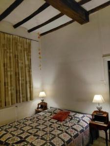 a bedroom with a bed and two lamps on tables at La Clairicourrière in Mignault