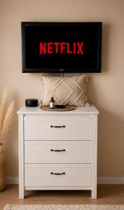 a tv on top of a white dresser at Boho Quiet Studio Kraków in Krakow