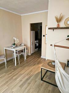 a living room with a table and a dining room at Boho Quiet Studio Kraków in Krakow