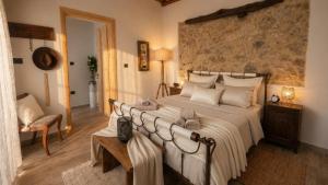 a bedroom with a large bed with white sheets at Villa Katrinia in Sitia