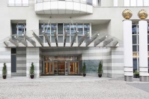 a large building with a large glass entry way at Sheraton Grand Warsaw in Warsaw