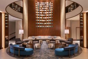 a hotel lobby with a table and chairs at Sheraton Grand Warsaw in Warsaw