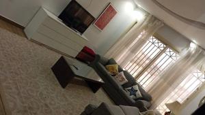 a living room with a couch and a window at فلل و شقق سحاب أبها in Abha