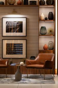 a living room with two chairs and a table at Sheraton Grand Warsaw in Warsaw +191 photos