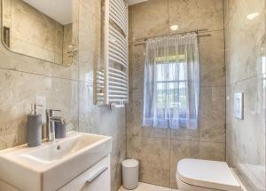 a bathroom with a sink and a toilet at Domki u Marii- agroturystyka in Bańska Niżna +38 photos