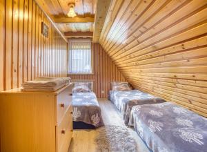 a room with two beds in a wooden cabin at Domki u Marii- agroturystyka in Bańska Niżna