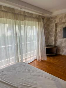 a bedroom with a bed and a large window at Atlantic Beach View Villa in El Jadida