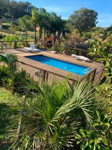 an image of a swimming pool in a house at Pousada Cristais do Rosa in Imbituba