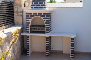 a blue and white brick oven sitting next to a wall at Villa Kaş B in Kaş