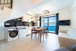 a kitchen and living room with a table and chairs at Villa Kaş B in Kaş