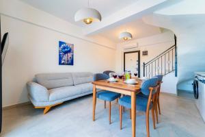 a living room with a table and chairs and a couch at Villa Kaş B in Kaş