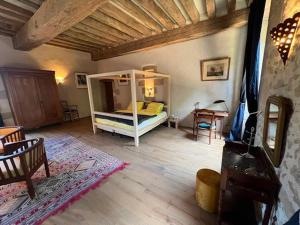 a bedroom with a white bed in a room at Lieu dit La Chassagne in Saint-Hilaire-le-Château