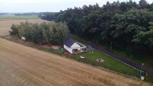 an aerial view of a house next to a field at Domek Las&Luz Moszna BALIA in Moszna