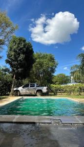 a truck parked next to a pool of water at Quinta Bommerl in Paso de la Patria