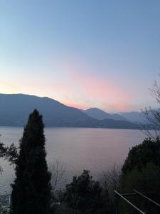 a view of a large body of water at sunset at Ferienhaus mit Privatgarten in Gambarogno