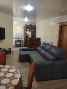 a living room with a couch and a table at Casa Ramos in Mogadouro